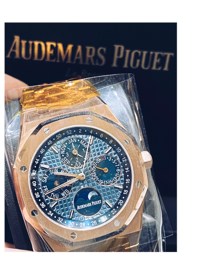 Luxury watch with blue face and gold casing, displayed against a dark background with 'Audemars Piguet' branding.
